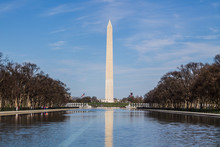 Washington Monument In Springtime With Reflecting Pool In The Foreground.  