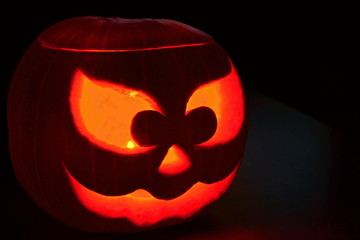 Halloween pumpkin in the dark with a candle inside