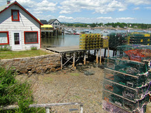 Lobster Traps On Wharf, With Boats In Harbor On Mount Desert Island, Acadia, Maine