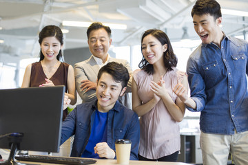 Business people cheering in office