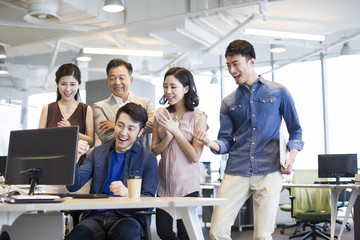 Business people cheering in office