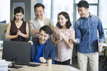 Business people cheering in office