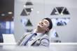 © Blue Jean Images - Young businessman resting in office