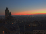 Fototapeta  - Bergamo - Old city (Citta Alta). One of the beautiful city in Italy. Lombardia. Evening sunset. Landscape on the old city, Cathedral, clock towers and the Po Valley.        