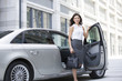 © Blue Jean Images - Beautiful businesswoman getting out of the car
