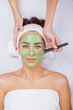 Young woman in a spa with algae facial mask. Woman in spa salon