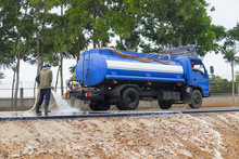 Water Cleaning At The Road With Water Truck