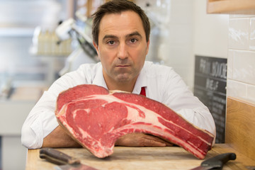 Wall Mural - Portrait of a butcher with meat