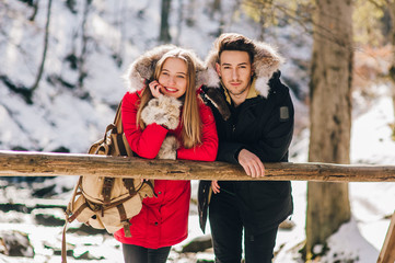 young couple in winter forest