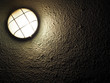 slatted lantern on a wall in the dark, luminous round lamp