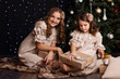 © _chupacabra_ - Two girls friends with gifts near christmas tree