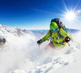 Canvas Print - Freeride skier on piste running downhill