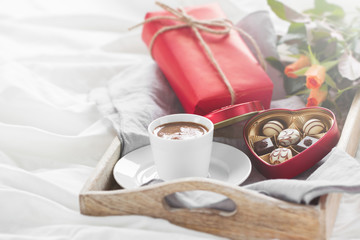 Wall Mural - Romantic breakfast with coffee, chocolate pralines, gift box and