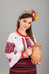 Wall Mural - Attractive woman wears Ukrainian is holding a jug national dress