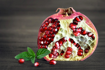 Wall Mural - Pomegranate half on wooden background