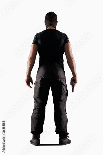 Fotografía Man in black uniform with gun isolated on white
