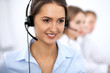 © rogerphoto - Call center. Focus on beautiful woman in headset