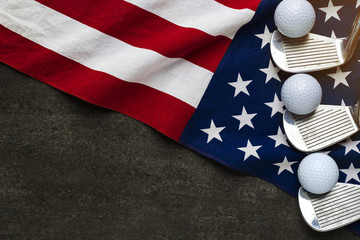 Wall Mural - Golf ball with flag of USA on wood table