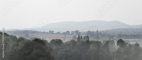 Leinwand Poster  Rolling Landscape on a foggy day
