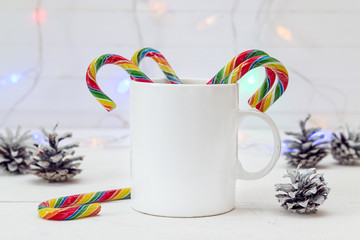 White coffee mug with Christmas Candy Canes and cones. Space for