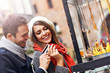 © Kalim - Young tourists shopping for souvenirs with credit card in Gdansk