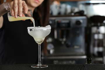 Wall Mural - Woman hands making cocktail on bar counter