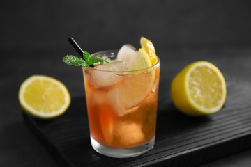 Poster - Glass of iced tea with lemon slices and mint on wooden cutting board