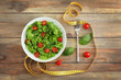 © Africa Studio - Fresh salad and measuring tape on wooden  background