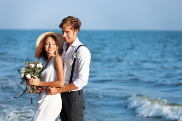 Wall Mural - Young happy couple on seashore