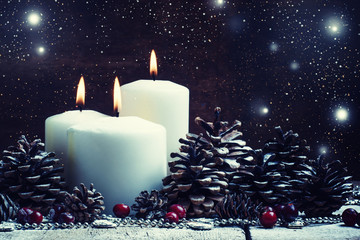 Wall Mural - White burning candle with pine cones and cranberries, Christmas