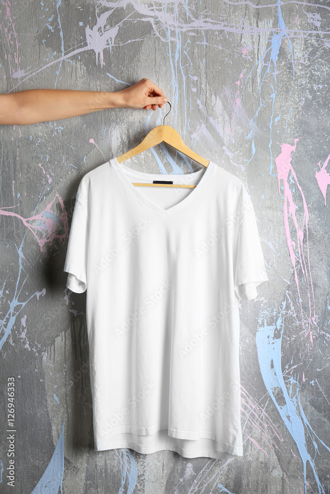 Blank white t-shirt on grunge background