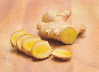 Wall Mural - Ginger root, slices of ginger root on the wooden background