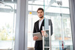 © Drobot Dean - Businesman with tablet entering the door in office