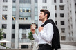 © Drobot Dean - Cheerful young businessman drinking coffee