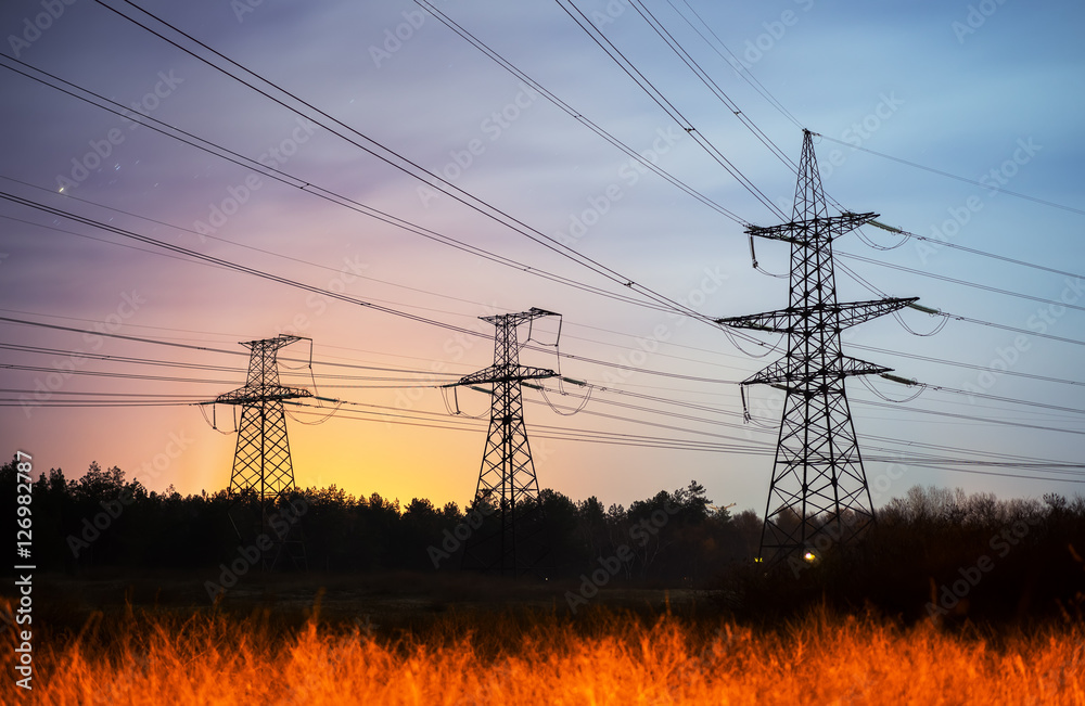 High voltage power tower and silhouette power lines sunset. Stock Photo ...