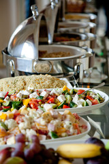 buffet table with salads and fruits