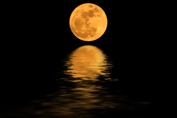 super moon yellow and shadows in the water.