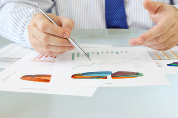 Fototapete - Businessman analyzing investment charts at his workplace