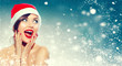 © Subbotina Anna - Christmas. Beautiful surprised woman in Santa's hat
