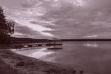 Fototapeta Pomosty - Wooded bridge in the lake between sunrise.