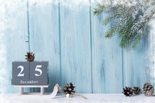 Christmas Background, Block Calendar With 25 December, Cones And Fir Branches, Wooden Background With Snow Frame