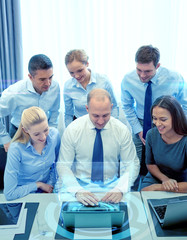 Poster - smiling business people with laptop in office