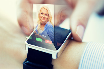 Canvas Print - close up of hand with incoming call on smart watch