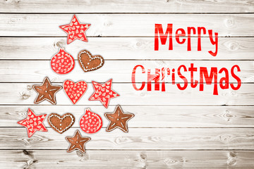 Wall Mural - Christmas greeting card, rustic ornaments on wood planks background creating the shape of a Christmas tree