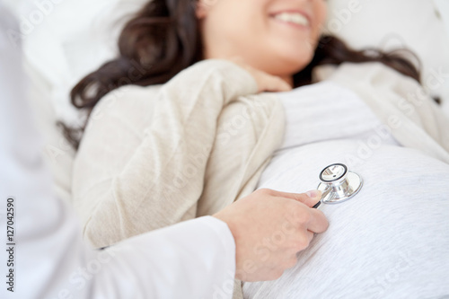 Fotografie, Obraz doctor with stethoscope and pregnant woman