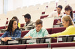 © Syda Productions - group of students with notebooks in lecture hall