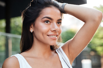 Poster - Happy pretty young woman staning and smiling outdoors