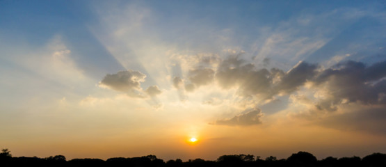 Wall Mural - beautiful sunbeam through cloud and sunset sky