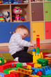 Two-year boy playing and learning in preschool