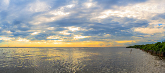Wall Mural - Panorama scene tranquil cloudy sea sunset .